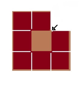 Fold the top right square diagonally down and to the left, and place it on top of the central square.